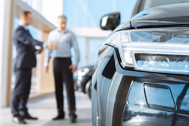 A car dealer talking to a customer