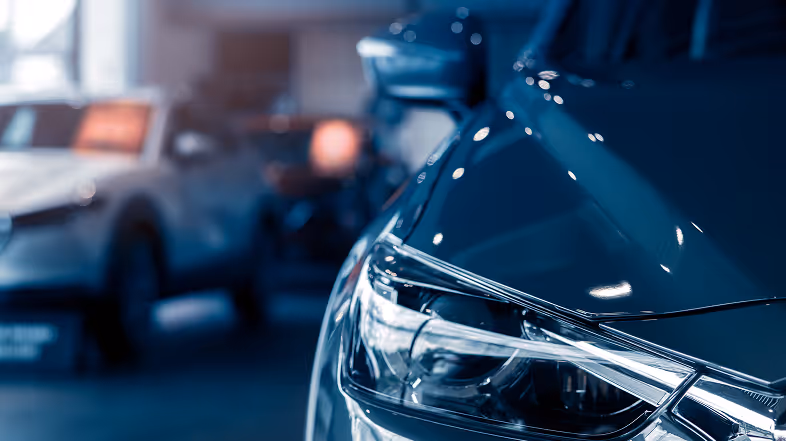 Closeup of a parked car inside a dealership show room